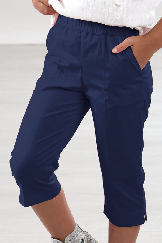 Pantalone modello capri in tela di cotone con tasche e spacchetti sul fondo
