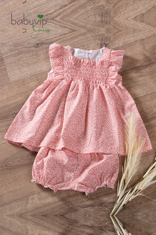 Vestitino neonata in tela di cotone organico con scollo quadro e punto smock
