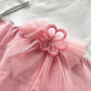Tutina in cotone elasticizzato con applicazione fiore e fiocco