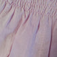 Body a camicia in mussola di cotone fantasia provenzale con profilo in contrasto al colletto in tela ricamata piega e bottoncini in madreperla e Short in tela di cotone ricamata con punto smock in vita e rouches al giro gamba