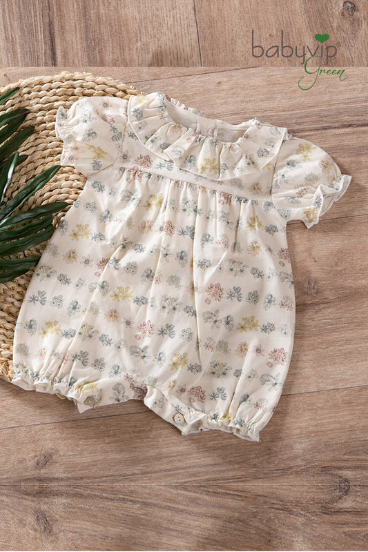 Pagliaccetto neonata in tela di cotone organico con balza allo scollo e maniche a palloncino
